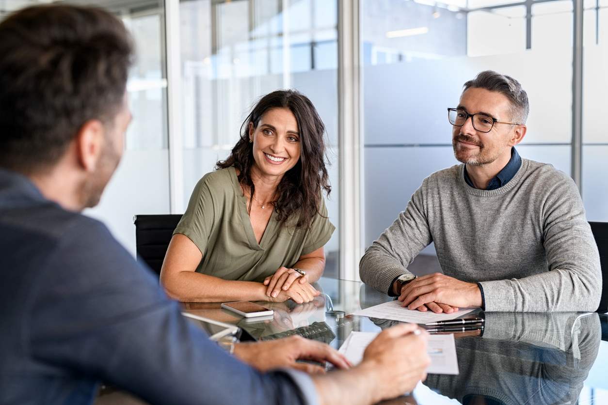 A couple going over a mortgage loan with their lender